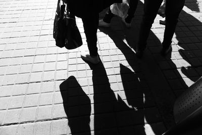 Low section of people walking on street