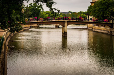 Arch bridge over river against sky