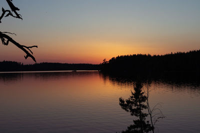 Scenic view of lake against orange sky