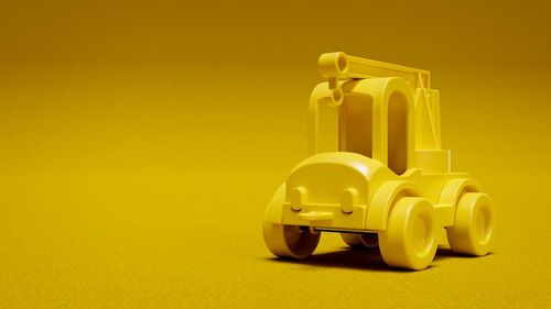 Close-up of toy car against yellow background