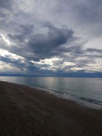 View of beach against cloudy sky