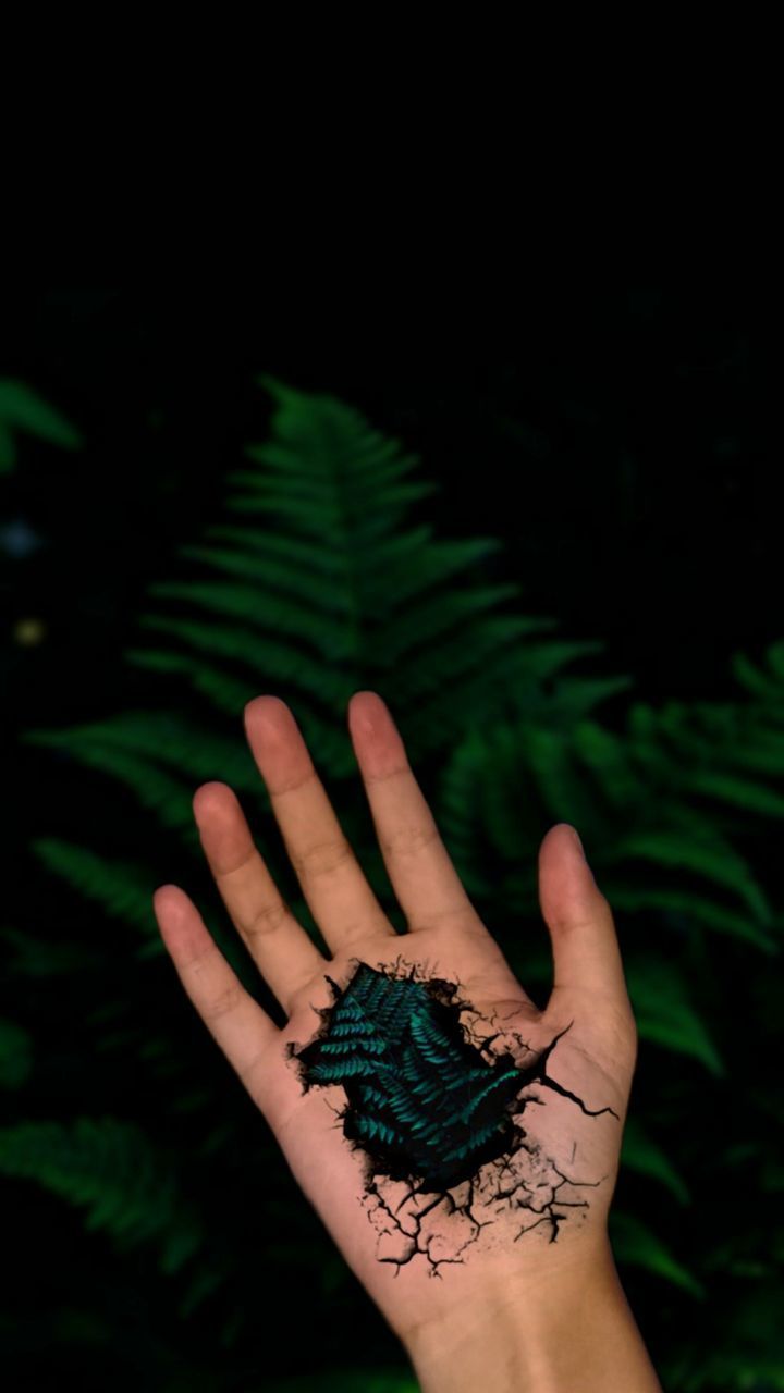 CLOSE-UP OF HAND ON PLANT