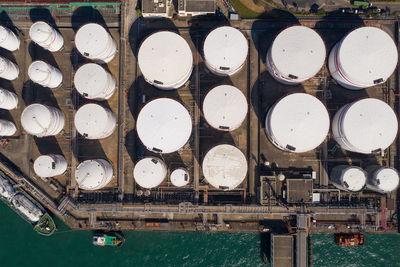 Directly above shot of oil storage tank by sea
