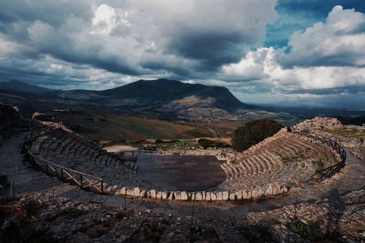 Panoramic view of mountain range against cloudy sky