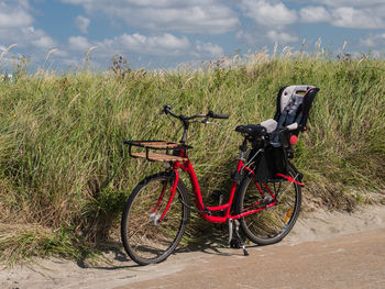 Bicycle on field against sky