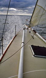 Sailboat sailing on sea against sky