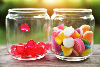 Close-up of candies in glass jars on table