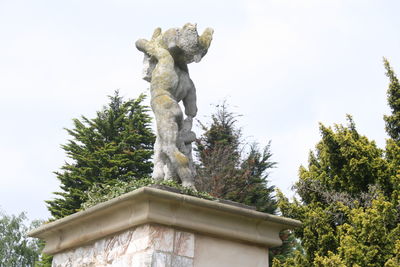 Low angle view of statue against sky