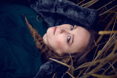 Fashionable woman in a green sweater and a long skirt keeps the fur