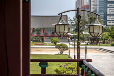 Street light by balcony of traditional building at michuhol park