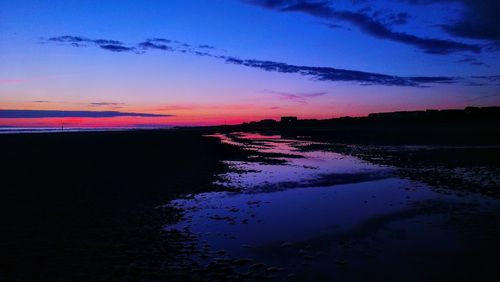 Scenic view of silhouette landscape against sky at sunset