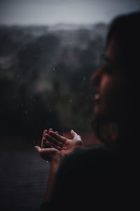 Close-up portrait of woman holding hands