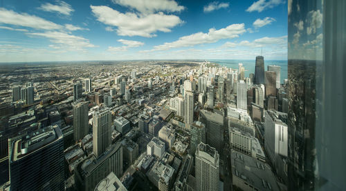 High angle view of modern buildings in city against sky