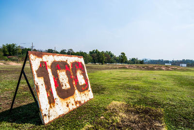 Close-up of abandoned house on field