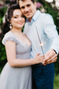 Midsection of couple holding hands