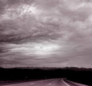 Road by mountain against sky