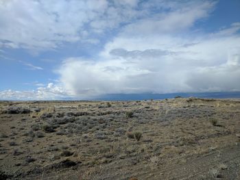 Scenic view of arid landscape against sky