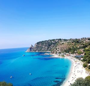 Scenic view of sea against clear blue sky