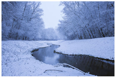 Scenic view of frozen lake against sky during winter