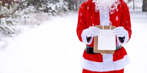 Rear view of woman holding snow