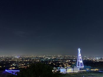 High angle view of illuminated buildings against sky at night