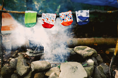 Drying wet socks on the bonfire during camping. socks drying on fire. active rest in forest.