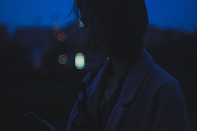 Portrait of silhouette woman against blue sky