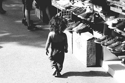 Rear view of woman walking on street in city