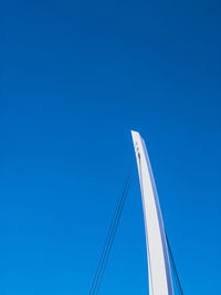 Low angle view of sailboat against clear blue sky