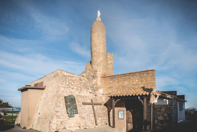 Low angle view of old building against sky