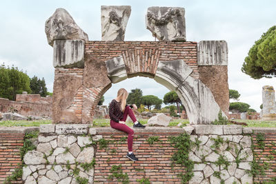 Woman jumping at historical building
