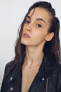 Close-up portrait of a beautiful young woman over white background