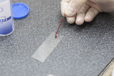 Cropped hand of person holding thermometer