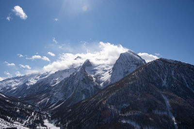 Scenic view of snowcapped mountains against sky