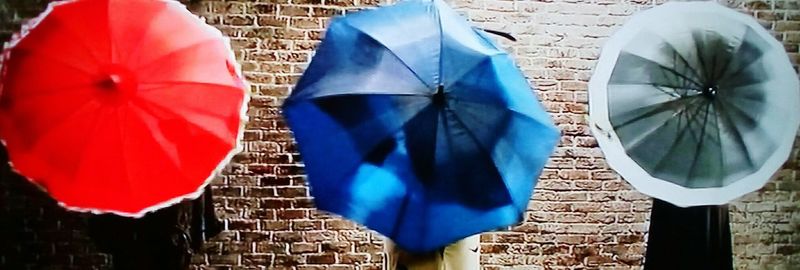 Close-up of umbrella against wall