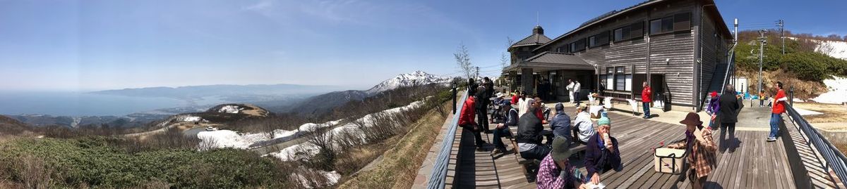 Panoramic view of people on mountain against sky