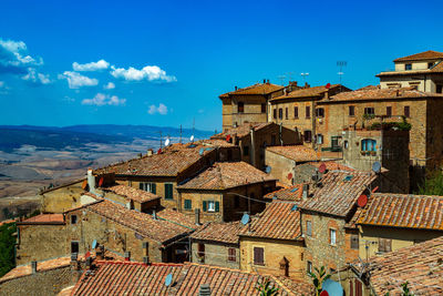 Buildings in town against blue sky