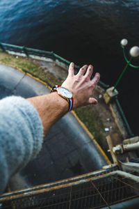 High angle view of man hand on railing