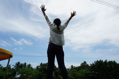 Rear view of man standing against sky