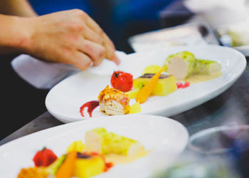 Close-up of person holding food on table