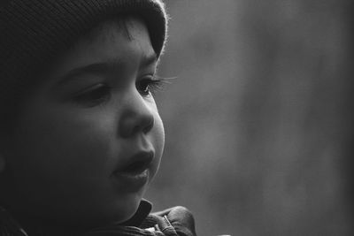 Close-up of cute thoughtful boy looking away