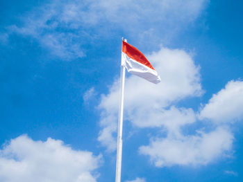 Low angle view of flag against sky