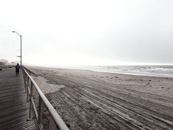 Narrow pathway along calm sea