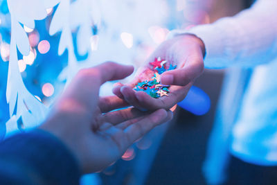 Close-up of hands holding blue eyes