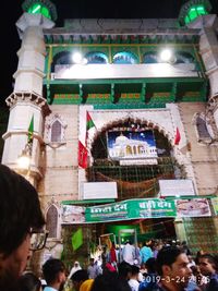 Group of people in front of building at night