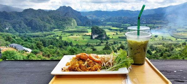 Close-up of thai food and drink on table.