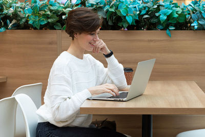 Young woman using laptop at home