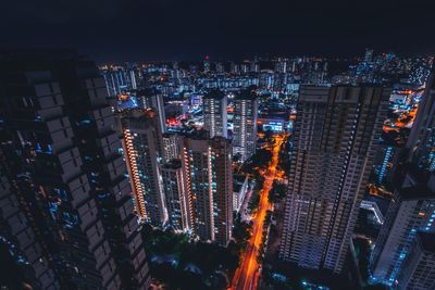 High angle view of illuminated buildings in city at night