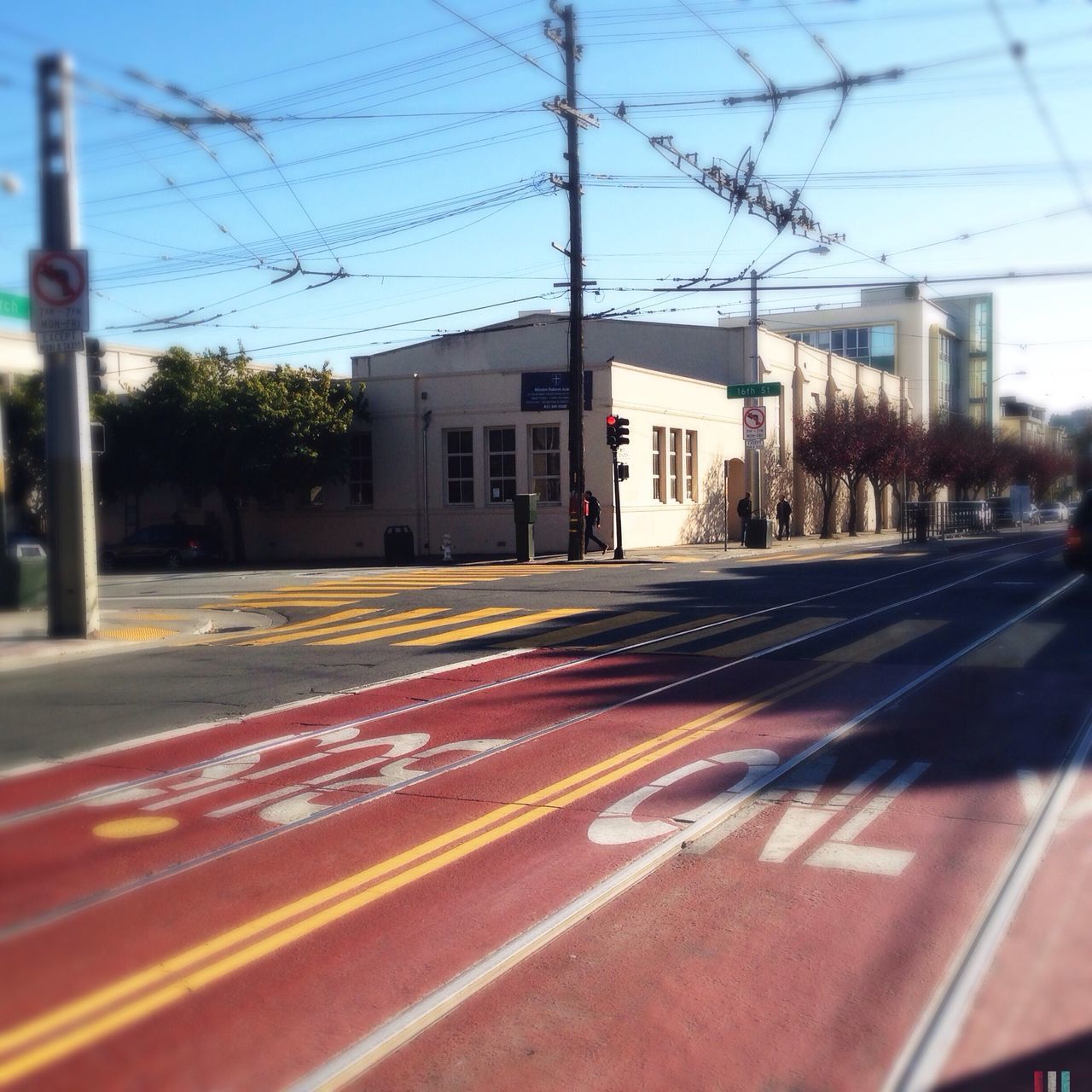 transportation, building exterior, architecture, built structure, road marking, road, sky, street, city, empty, the way forward, railroad track, railroad station platform, railroad station, city life, outdoors, red, no people, street light, car