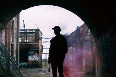 Rear view of silhouette man standing in city